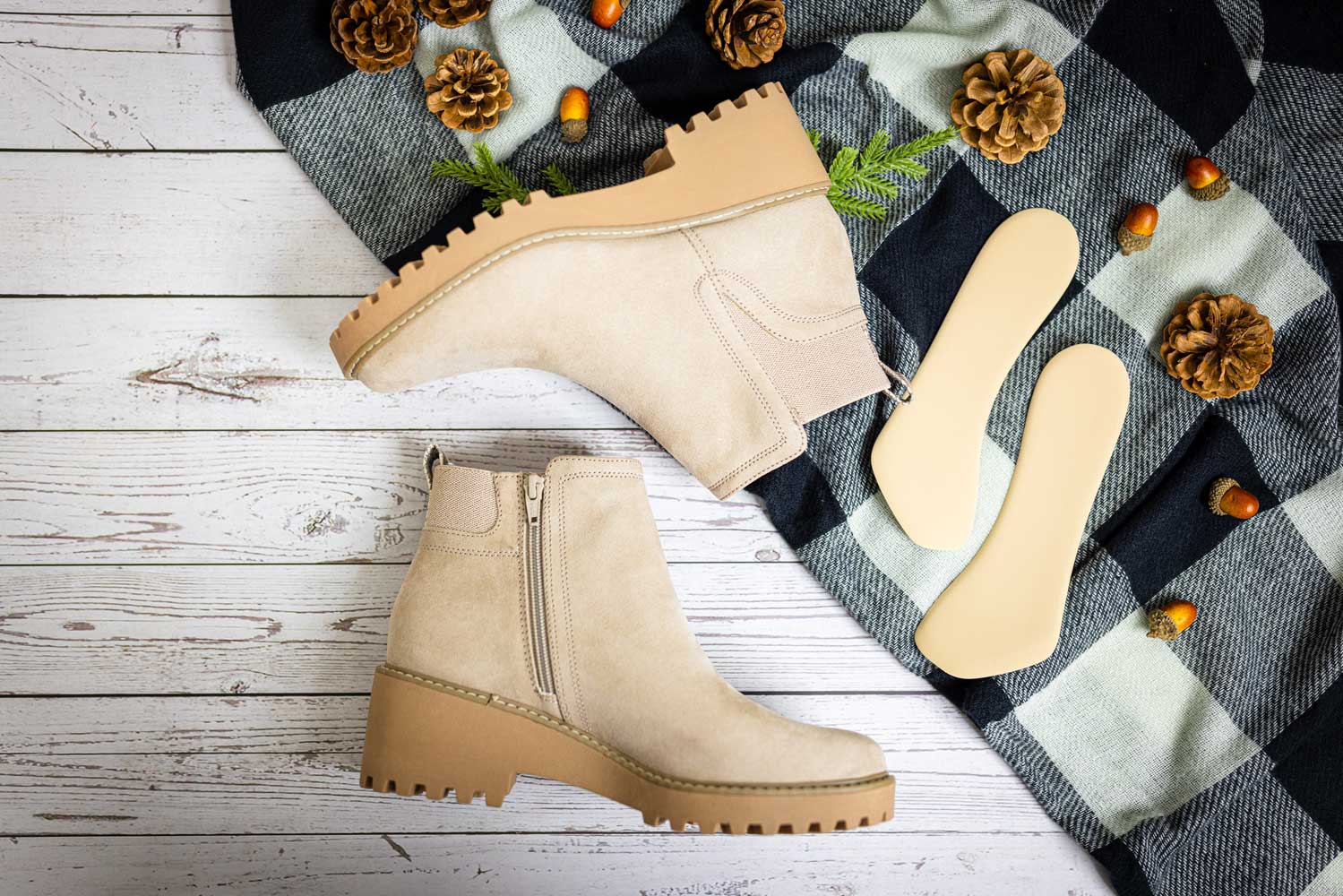 Khaki colored boots sitting next to khaki 3/4 insert cushions by Foot Petals.