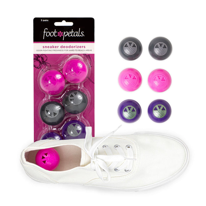 Sneaker Deodorizers in pink packaging, odor-fighting freshness for hard-to-reach areas, pink, dark gray, and purple sneaker balls, pink deodorizer in white sneaker #color_girly-girl-3-pairs
