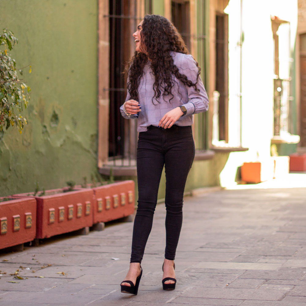 Girl walking down sidewalk while wearing black wedges with Foot Petals 3/4 Insert Cushions inside #color_assorted-2-pairs