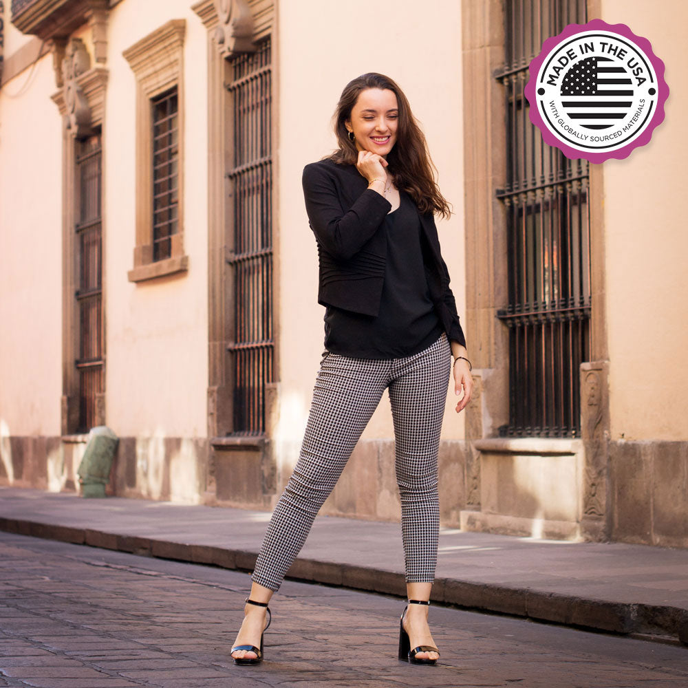 Woman standing on stone sidewalk while wearing black high heels with Foot Petals Ball of Foot Cushions inside #color_black