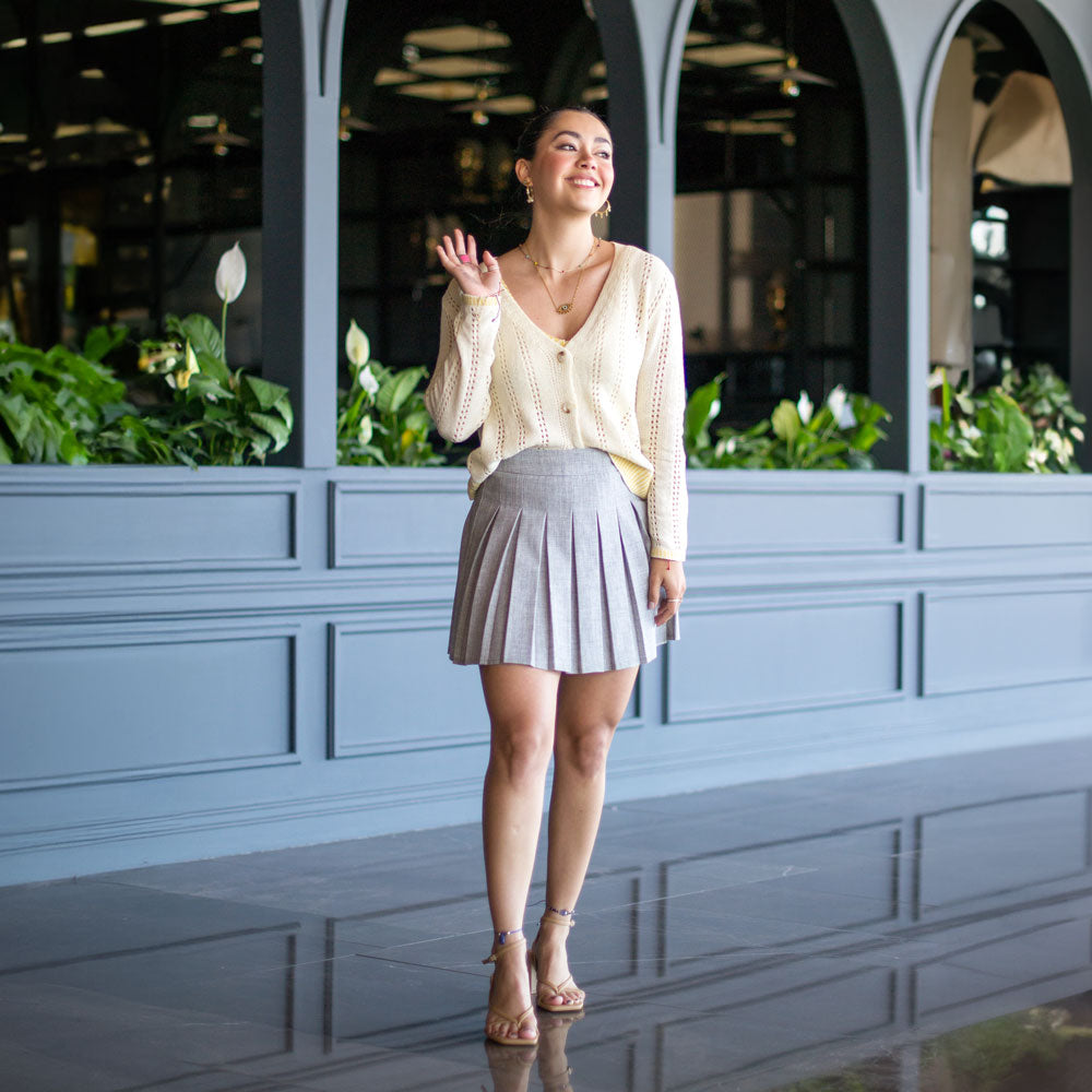 Woman standing on shiny, slick floor while wearing high heeled sandals with Foot Petals No-Slip Grips on the bottom